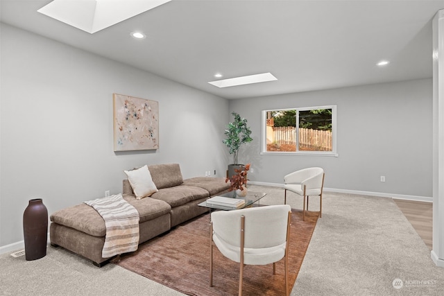 living room featuring hardwood / wood-style floors and a skylight