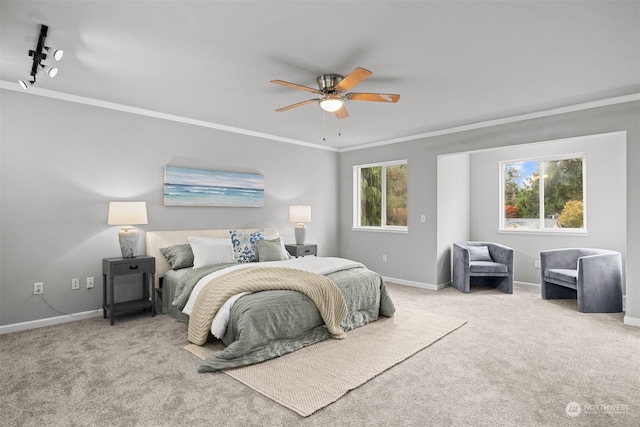 bedroom with ornamental molding, light carpet, multiple windows, and ceiling fan