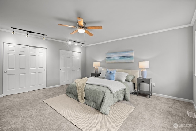 bedroom with ceiling fan, light carpet, and ornamental molding