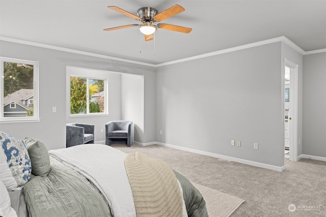 bedroom featuring ceiling fan, crown molding, and light colored carpet