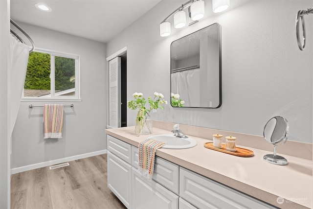 bathroom featuring vanity and hardwood / wood-style floors