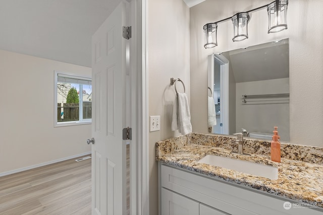 bathroom featuring vanity and hardwood / wood-style floors