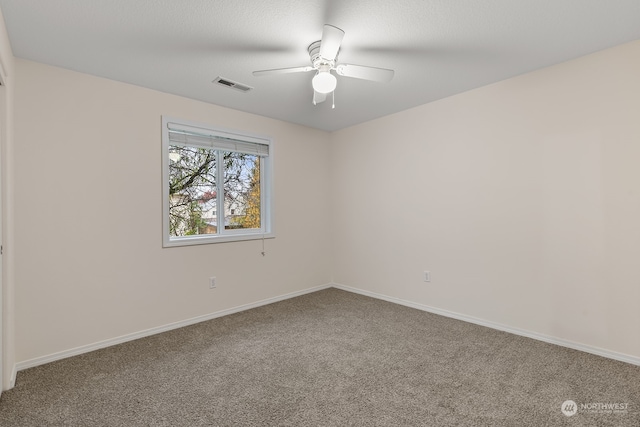 spare room featuring ceiling fan and carpet floors