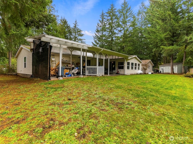 back of property with a storage shed and a lawn