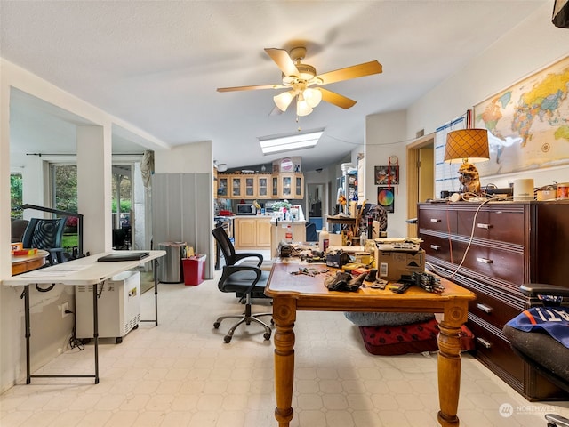 office area featuring ceiling fan, a workshop area, and vaulted ceiling