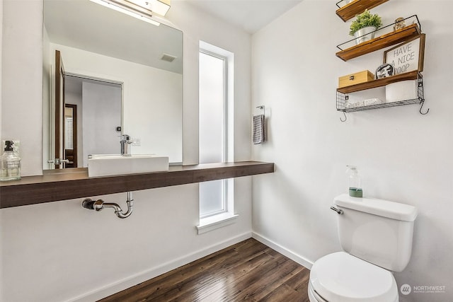 bathroom featuring toilet, hardwood / wood-style flooring, and sink