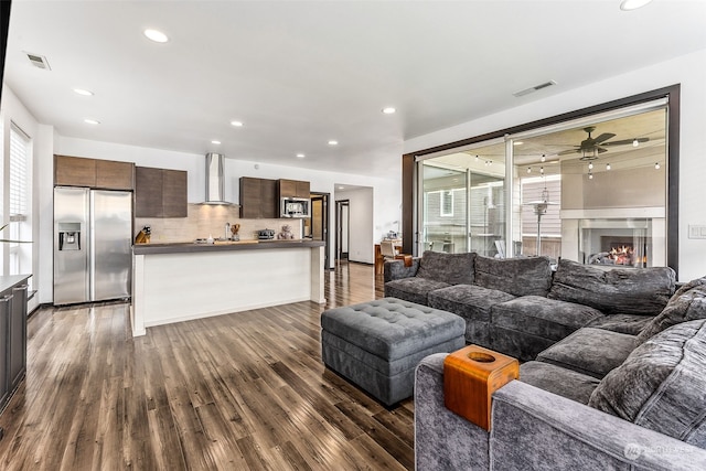 living room with dark hardwood / wood-style floors and ceiling fan