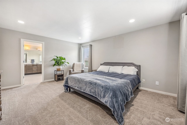 bedroom featuring connected bathroom and carpet flooring