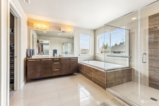 bathroom featuring vanity, independent shower and bath, and tile patterned flooring