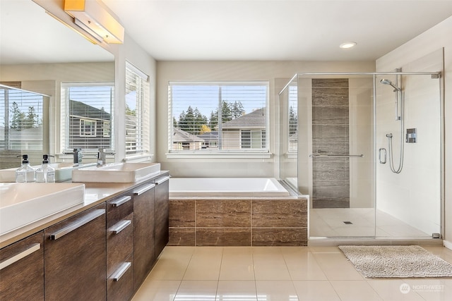 bathroom featuring vanity, tile patterned floors, and plus walk in shower