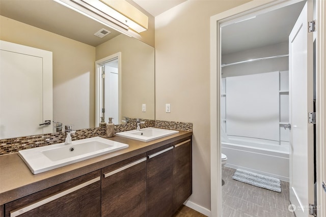 full bathroom featuring vanity, toilet, and washtub / shower combination