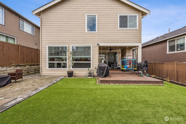 back of house featuring a patio area, a yard, and ceiling fan