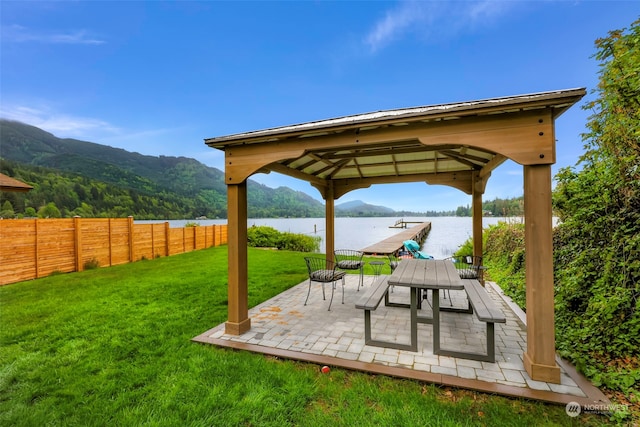 view of home's community with a gazebo, a yard, a patio, and a water and mountain view