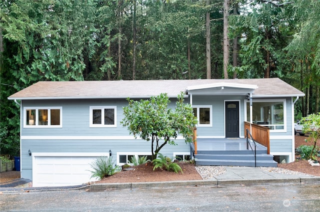 view of front of property featuring covered porch and a garage