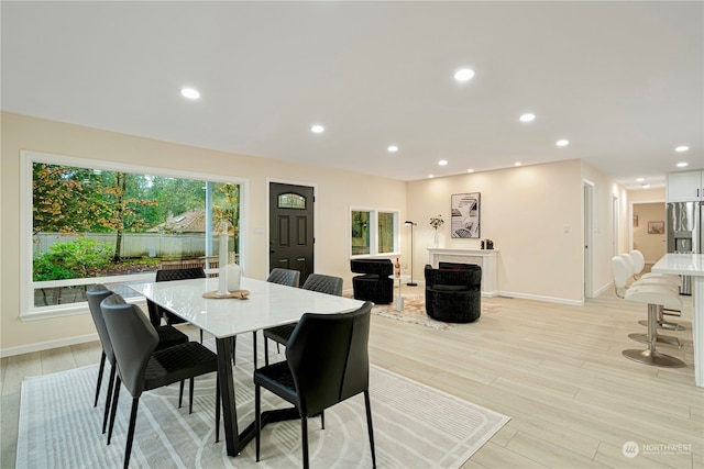 dining space with light hardwood / wood-style flooring