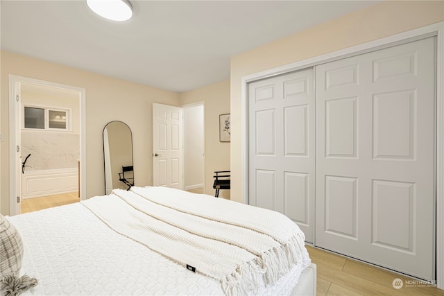 23405 NE 73rd St, Redmond, WA 98053 - bedroom featuring connected bathroom, a closet, and light hardwood / wood-style floors