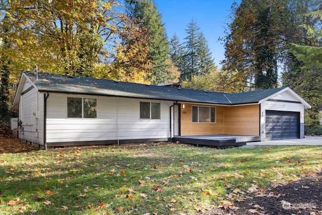 single story home featuring a garage and a front lawn