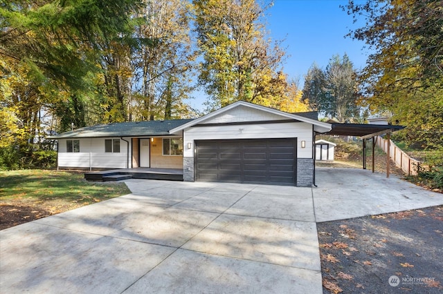 single story home with a garage and covered porch