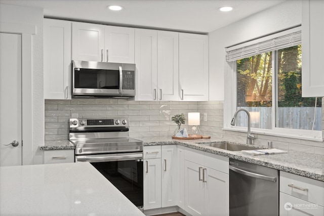 kitchen featuring white cabinetry, stainless steel appliances, and sink