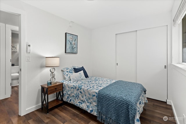 bedroom with a closet and dark hardwood / wood-style floors