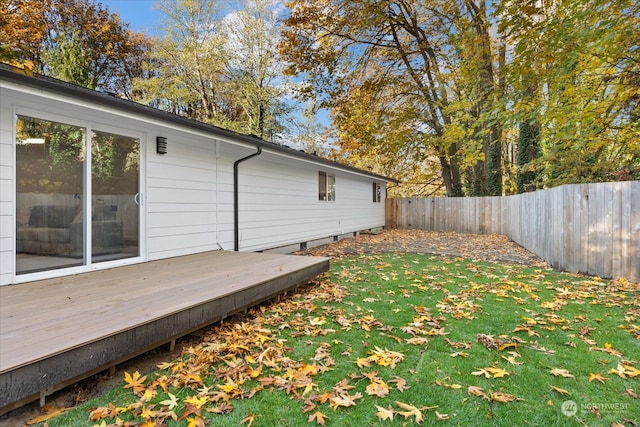 wooden terrace featuring a lawn