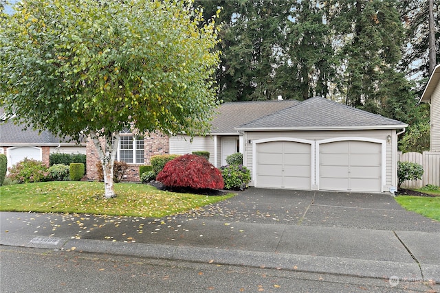 view of front of house featuring a garage and a front yard