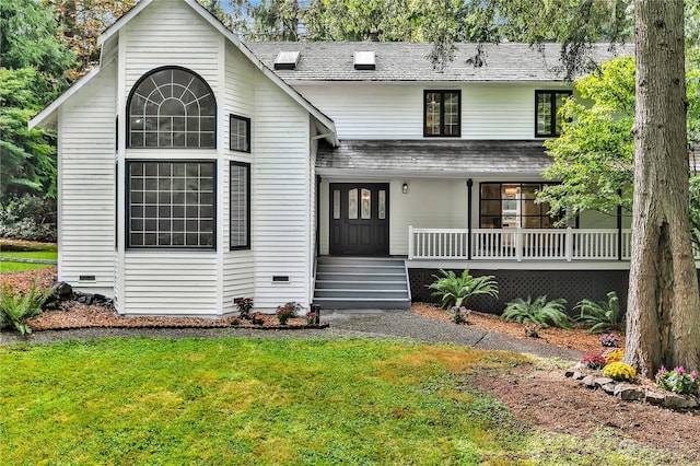 view of front of house with covered porch and a front lawn