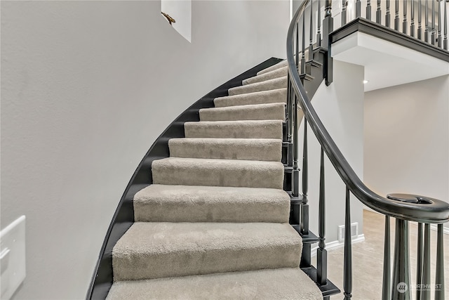 stairway featuring wood-type flooring