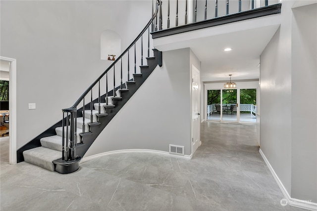 staircase featuring a chandelier