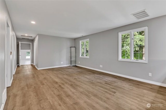 unfurnished room with light hardwood / wood-style floors and plenty of natural light