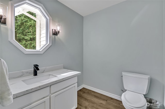 bathroom featuring hardwood / wood-style floors, toilet, and vanity