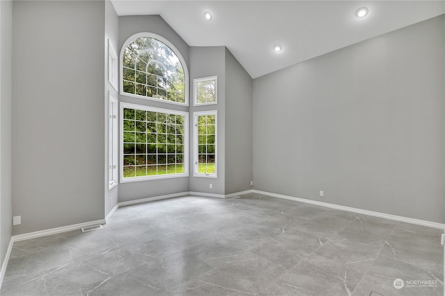 spare room with high vaulted ceiling