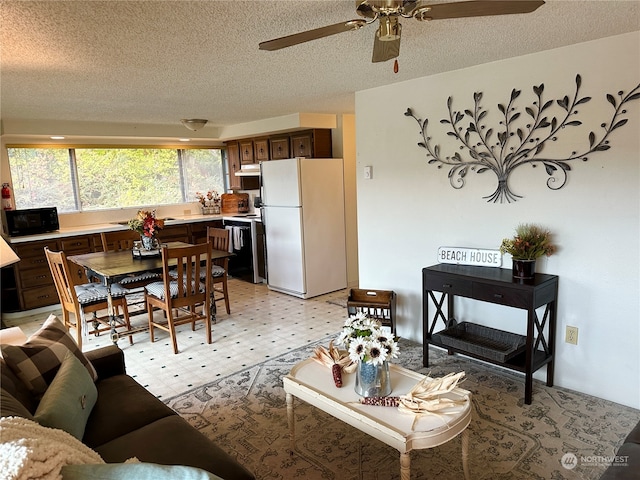 living room with a textured ceiling and ceiling fan