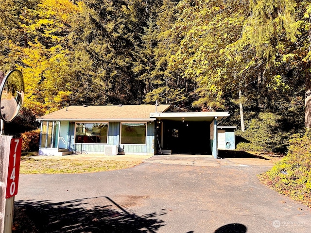 single story home with central AC and a carport