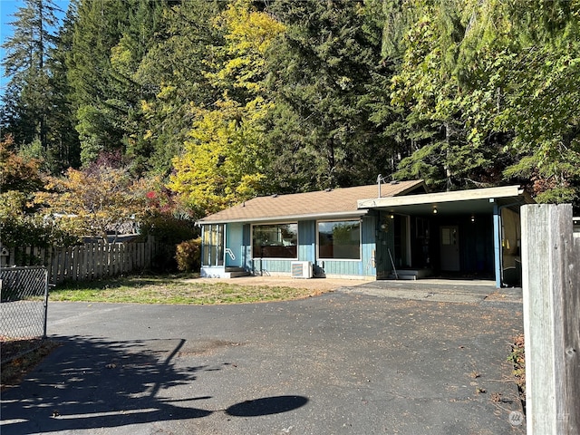 view of front of property featuring central AC and a carport