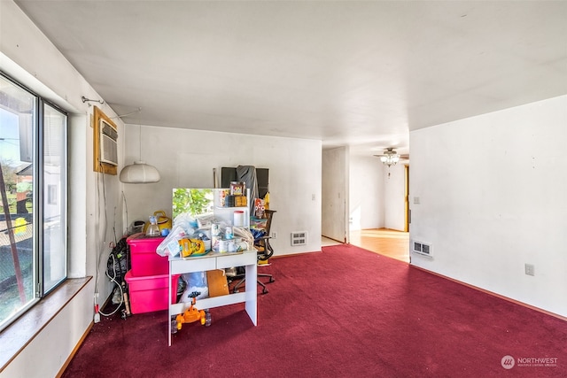 recreation room featuring ceiling fan, carpet, and a wall mounted AC