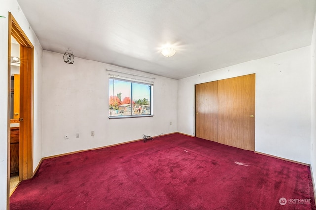 unfurnished bedroom featuring a closet and carpet flooring