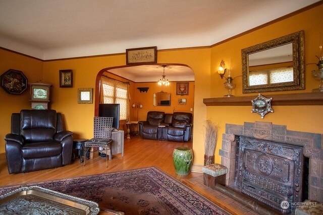 9346 Nels Nelson Rd NW, Bremerton, WA 98311 - living room featuring arched walkways, wood finished floors, and crown molding