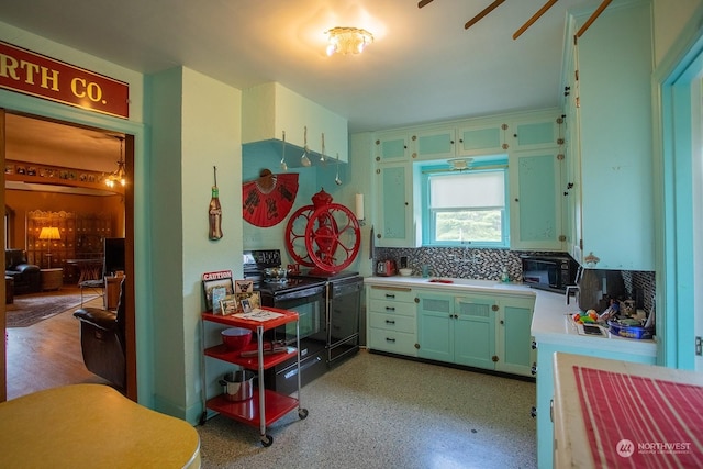 9346 Nels Nelson Rd NW, Bremerton, WA 98311 - kitchen featuring light countertops, black range with electric stovetop, backsplash, and ceiling fan