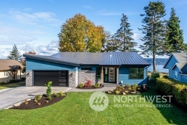 view of front of home with a front lawn and a garage