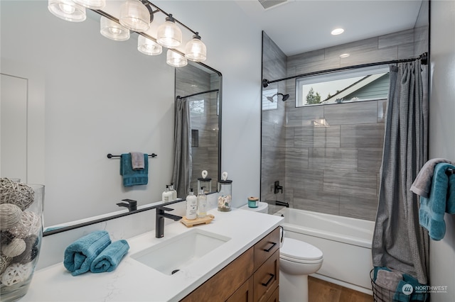 full bathroom featuring toilet, hardwood / wood-style flooring, vanity, and shower / bath combination with curtain