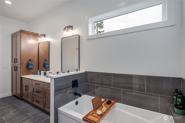 bathroom with vanity, a tub to relax in, and hardwood / wood-style floors