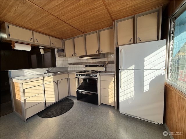 kitchen with wood ceiling, backsplash, black range oven, sink, and white refrigerator