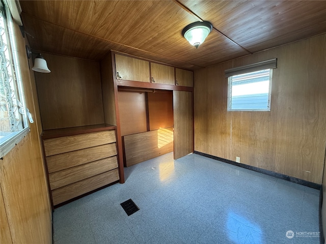 interior space with wood walls, a closet, and wooden ceiling