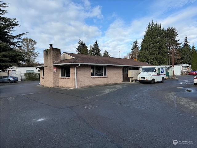 10515 Woodinville Dr Unit 23, Bothell, WA 98011 - view of front of property with a chimney and uncovered parking