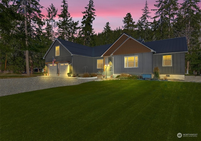 view of front of house with a lawn and a garage