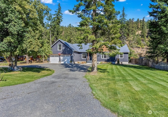 view of front of house with a garage and a front lawn