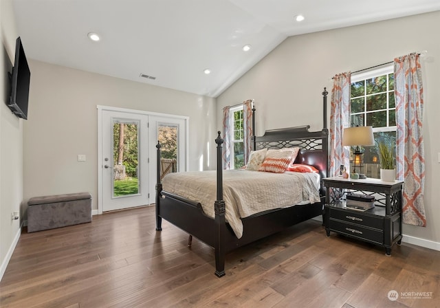 bedroom with dark wood-type flooring, access to outside, multiple windows, and lofted ceiling