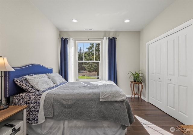 bedroom with a closet and dark wood-type flooring