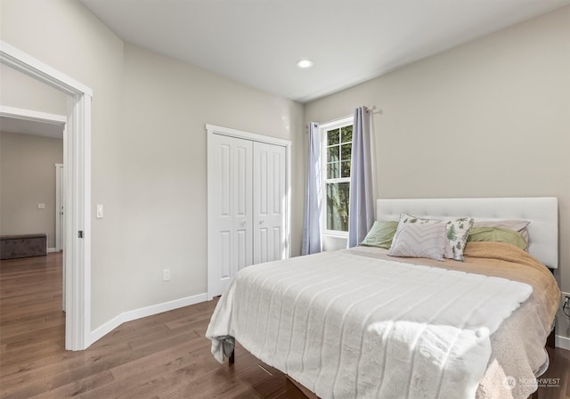 bedroom with a closet and dark hardwood / wood-style flooring